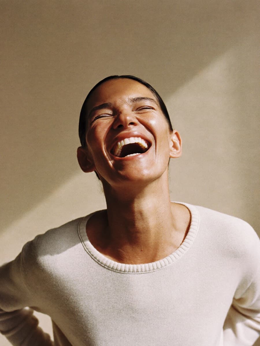 Woman laughing in warm light